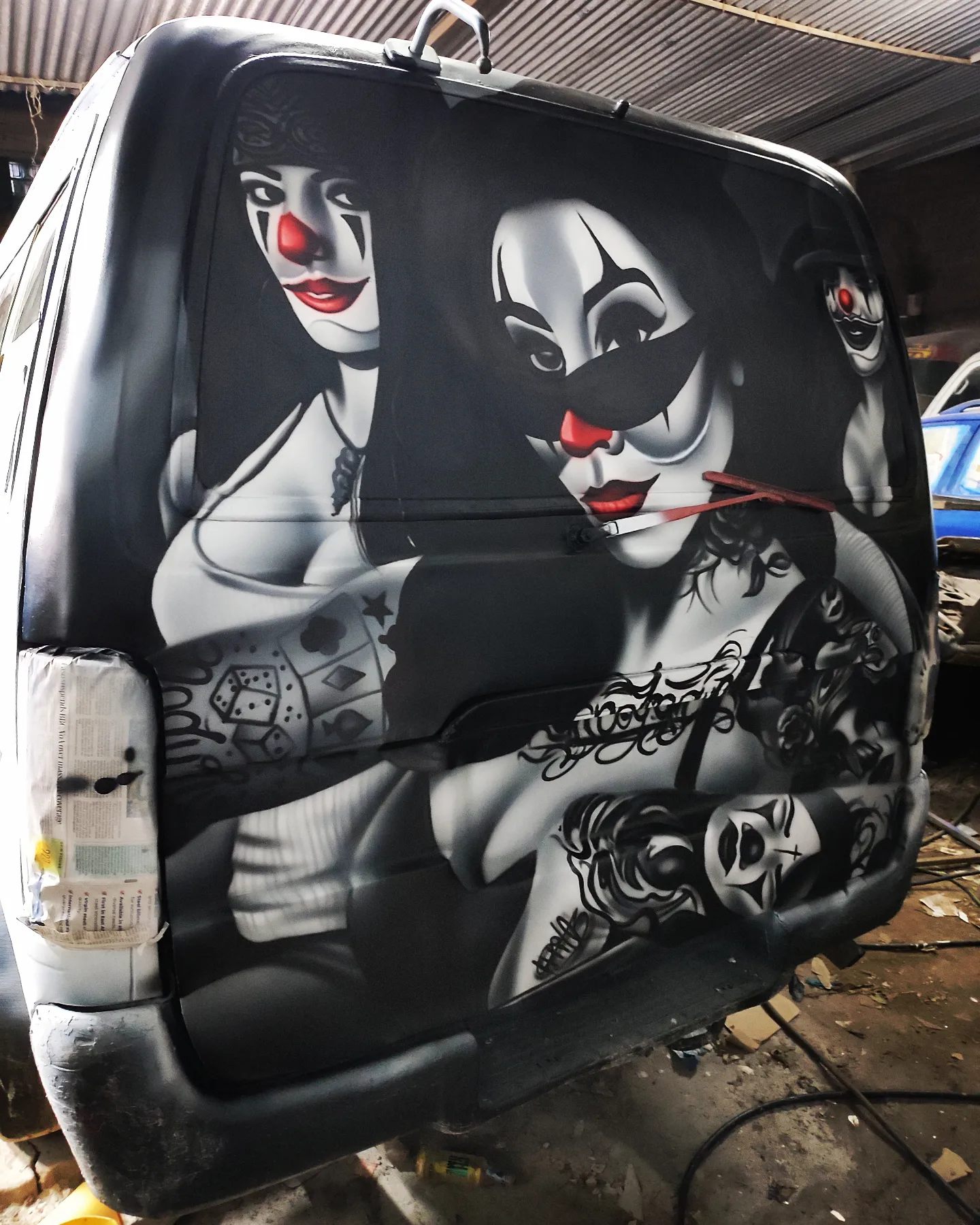 Black van with black and white clown airbrush art by Setik