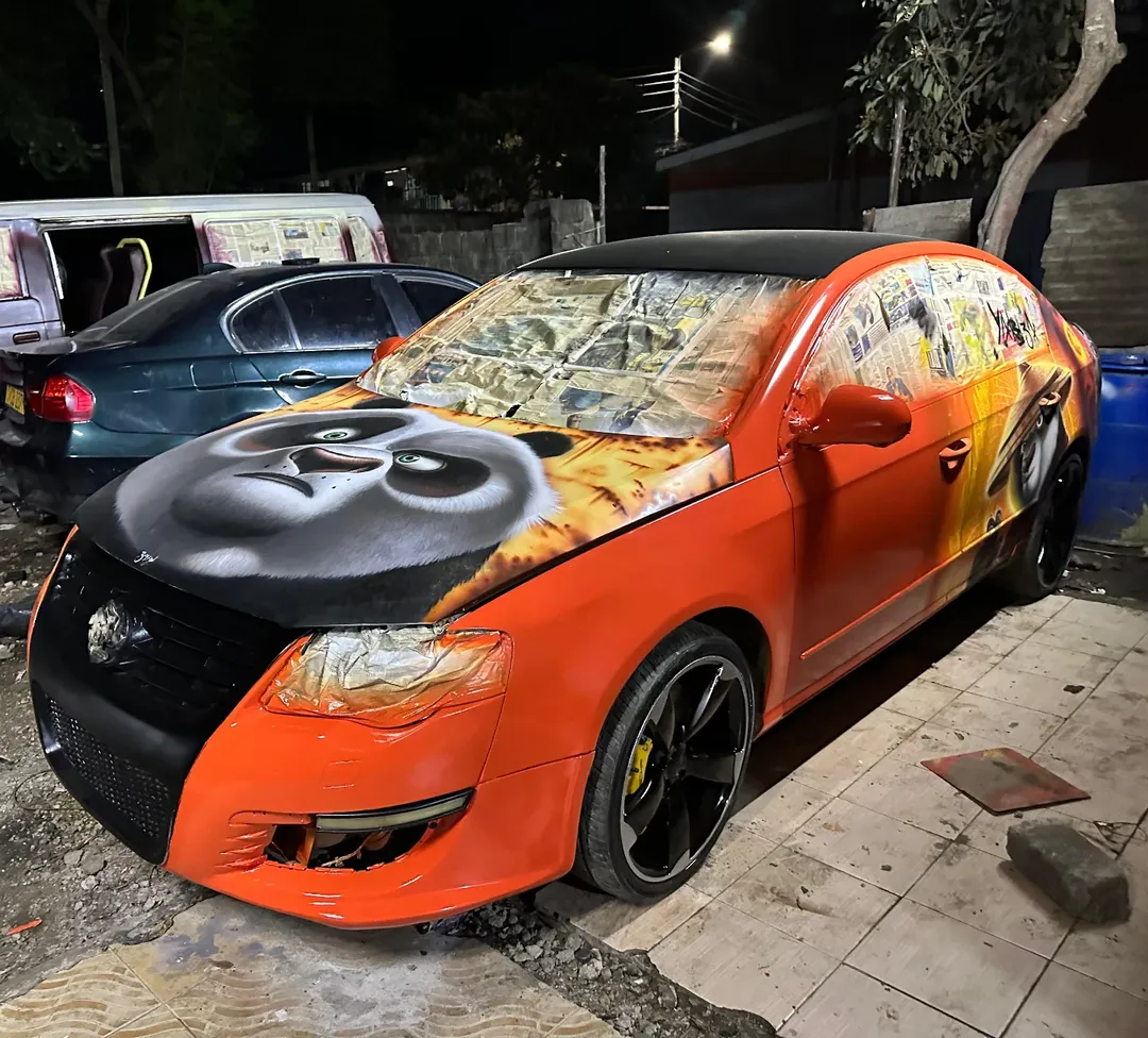 Orange VW with Kung Fu Panda hood art at night